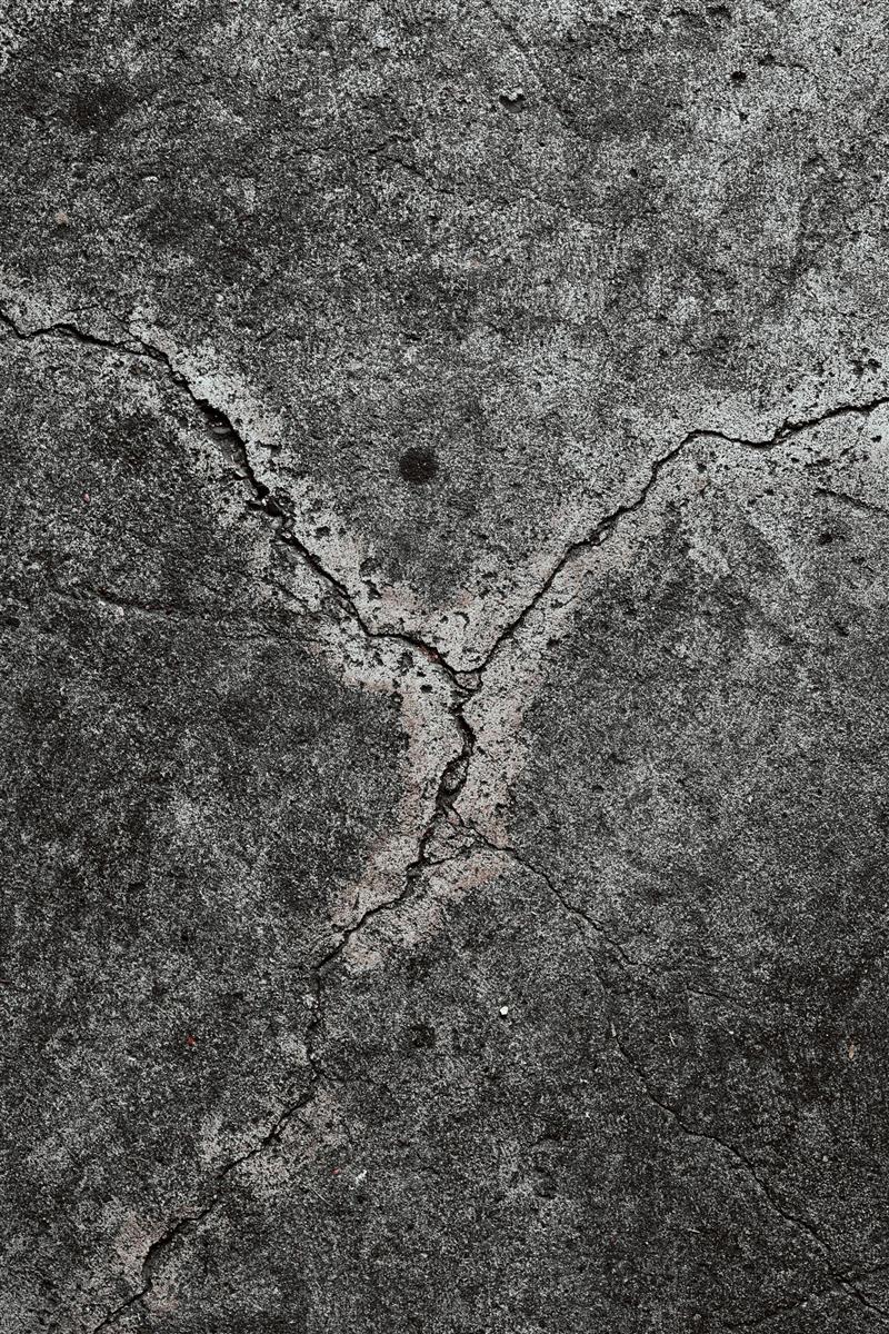 Different crack patterns on a concrete wall